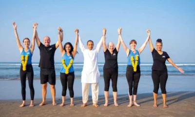 Himalaya Yoga Valley teaching faculty on the beach, representing trusted yoga certification paths in 2025